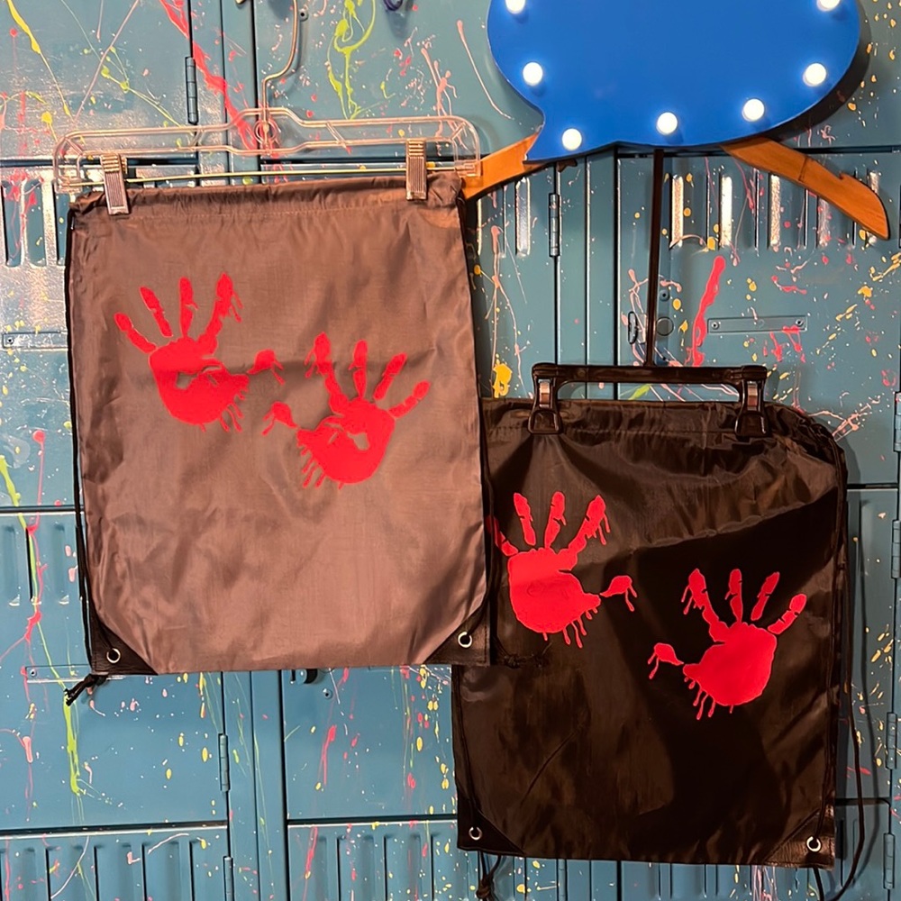 Tees by Trace. Sling backpacks. Halloween, bloody handprints.